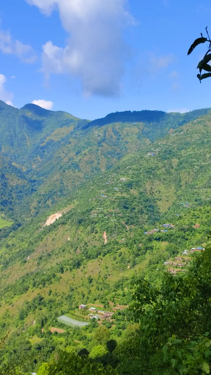 Terraced green hillsides of Thulo Lumpek, Gulmi, under a blue sky